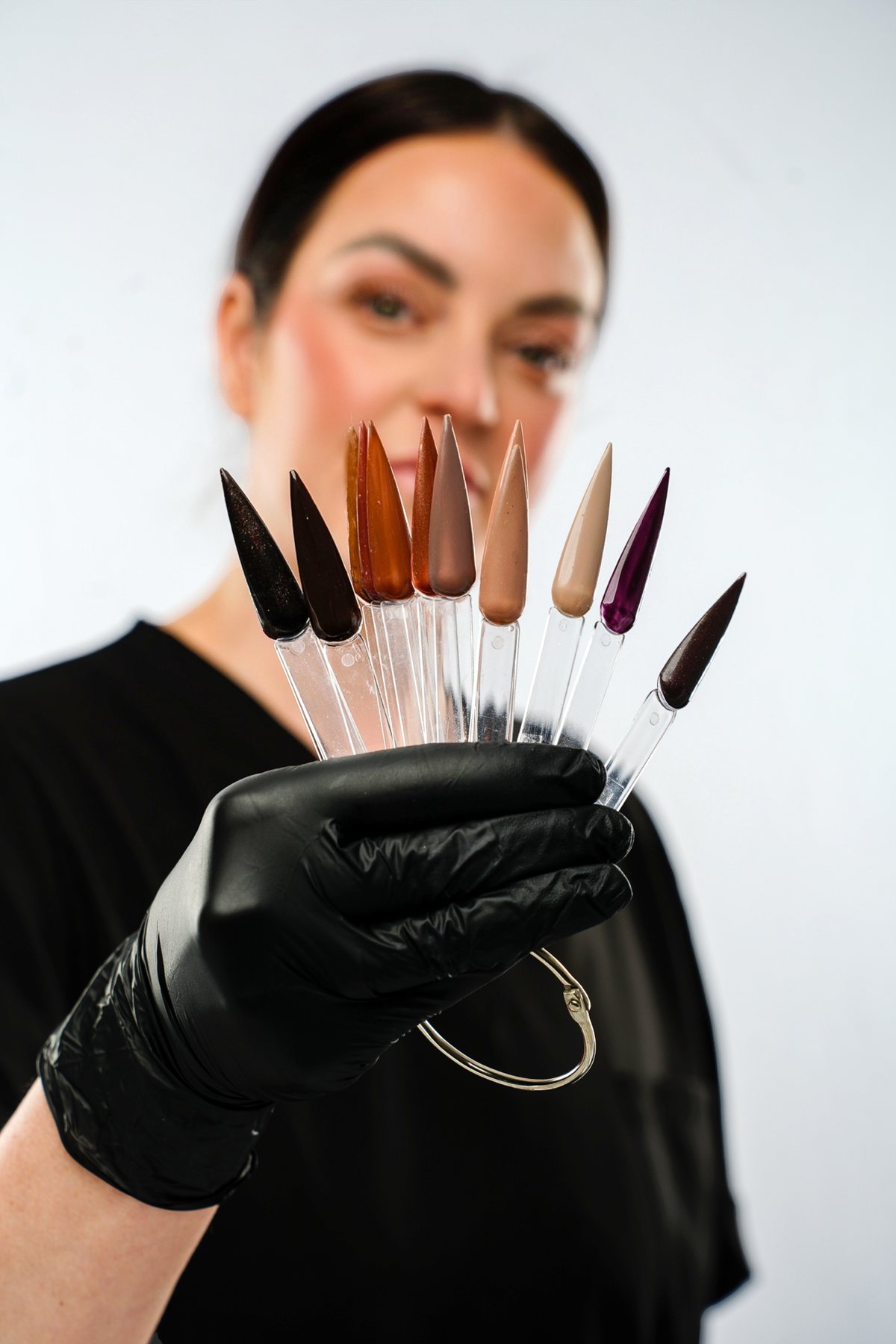 Lorraine holding a fan of gel polish colour swatches at Hidden Beauty
