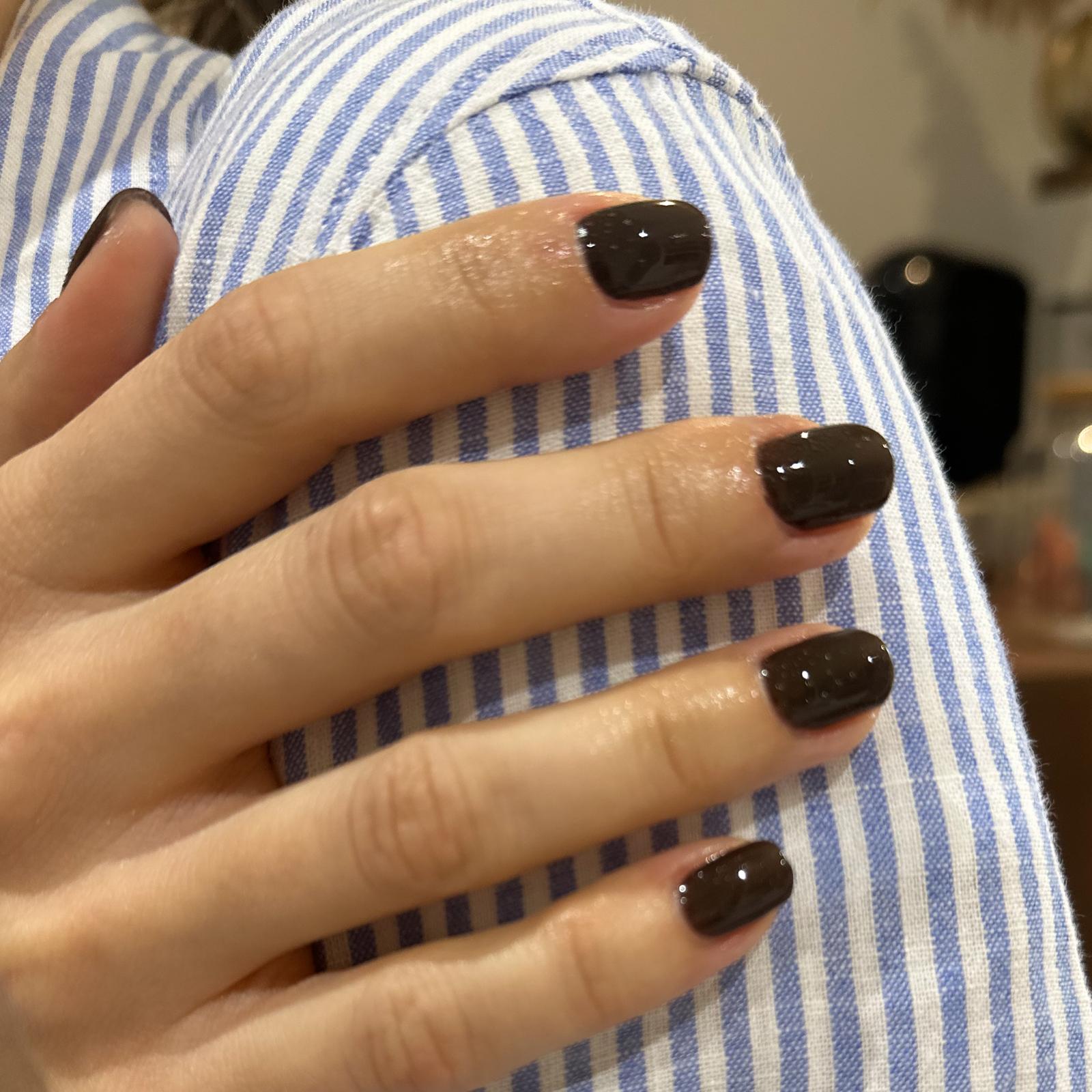 A dark chocolate brown gloss gel manicure on short square nails